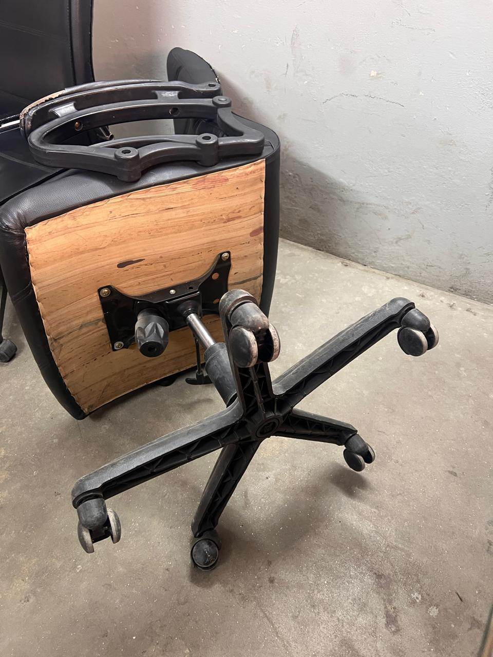 The same office chair after repair, with a new hardwood seat base fitted and the tilt mechanism plate remounted on solid timber.